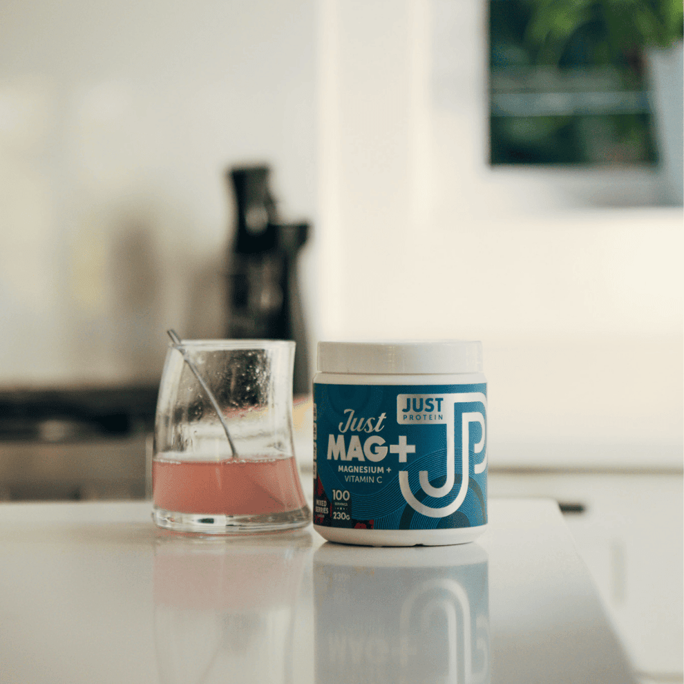 Just Mag+ berry drink beside the tub on a kitchen counter